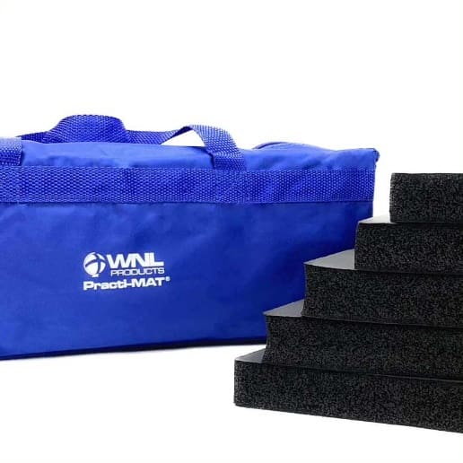 A blue bag with four black foam blocks next to it.